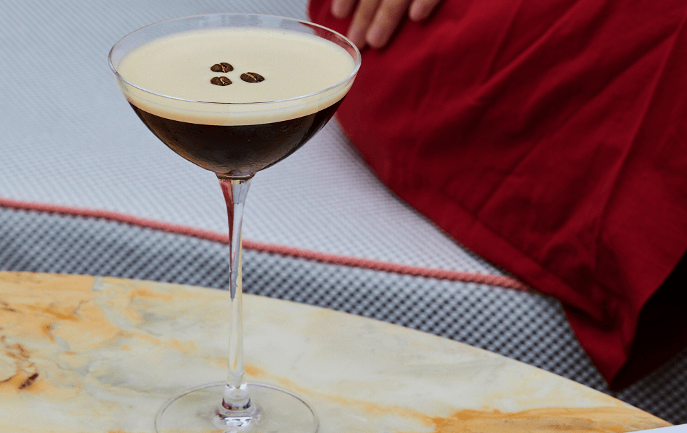 An espresso martini on a marble table.